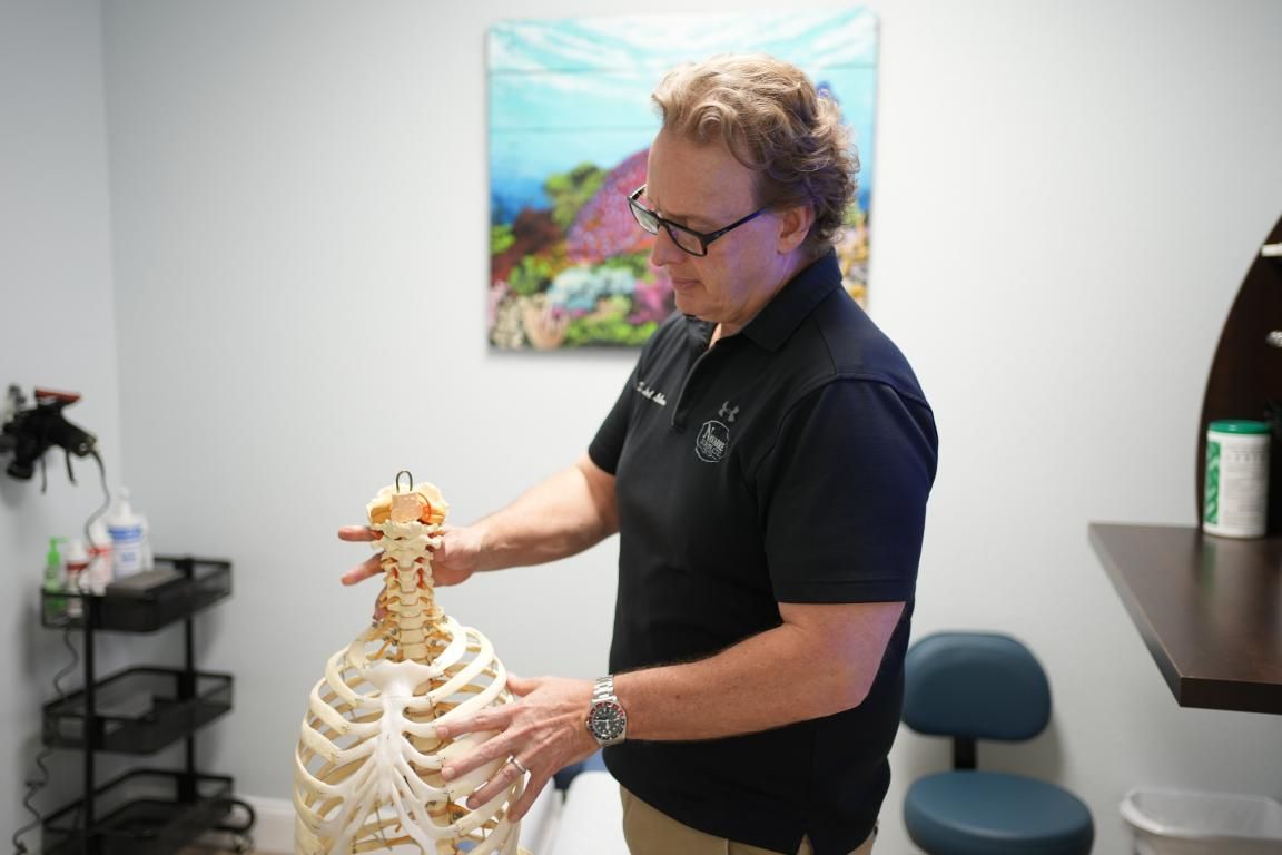 Dr. Llaird Likens holds an anatomical skeleton